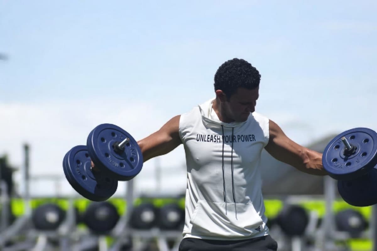 Methodical gym training setup with barbell and notebook