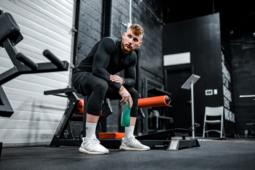 Athlete reviewing their ForgeLogbooks training journal between sets