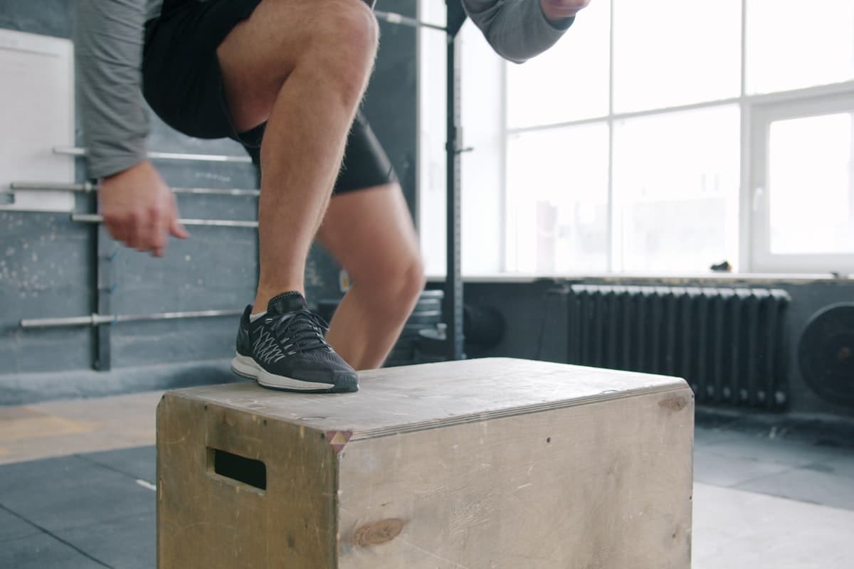 CrossFit athlete writing in a logbook between rounds in a box gym