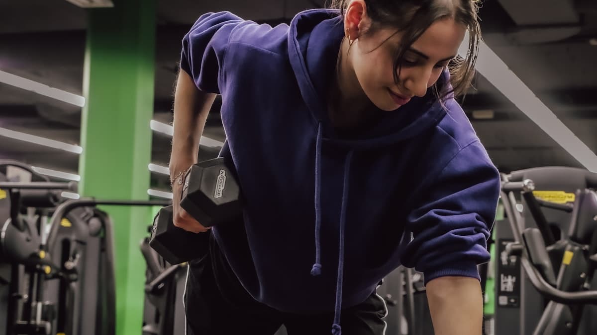 Young person lifting weights in a university recreation center