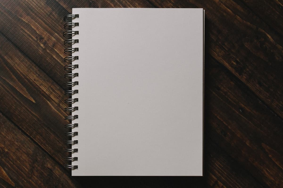 Blank notebook compared to a structured logbook planner