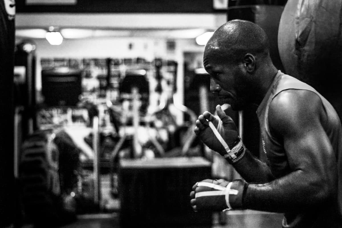 Athlete in gym reviewing notes and considering training changes