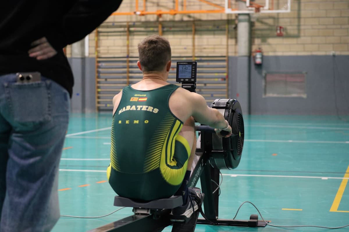 Man rowing on a machine in a gym for conditioning work