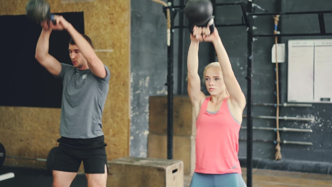 Kettlebell and open training logbook on a gym floor