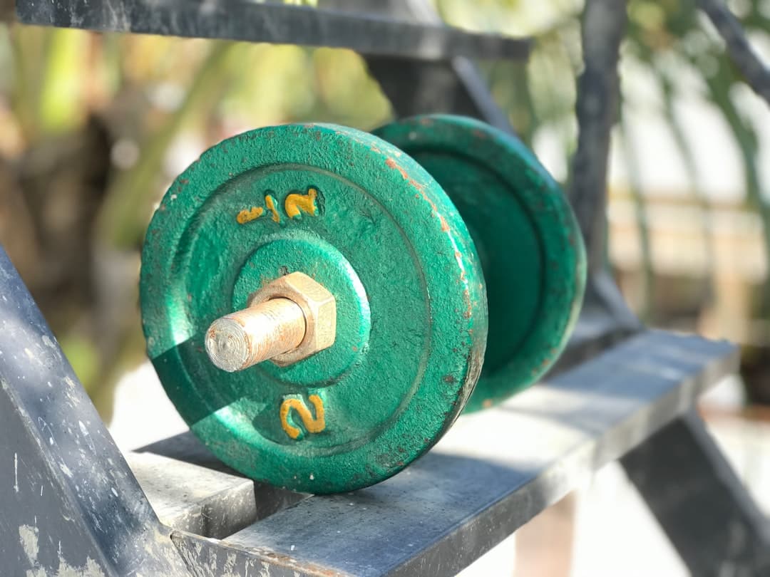 Olympic weightlifter reviewing a training journal between snatch attempts on the platform