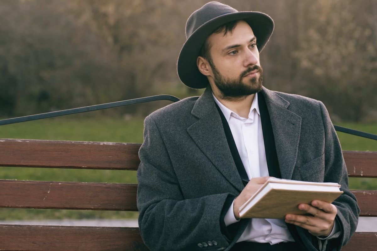 Person reviewing notes in a notebook with focused attention