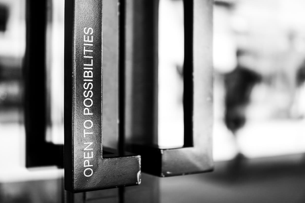 Powerlifter reviewing a detailed training logbook between heavy squat sets in a powerlifting gym
