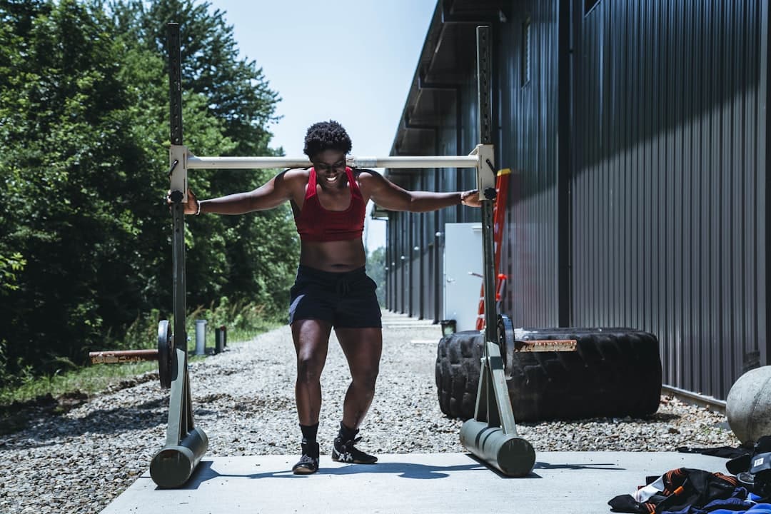 Strongman athlete logging implement work in a ForgeLogbooks training journal between events
