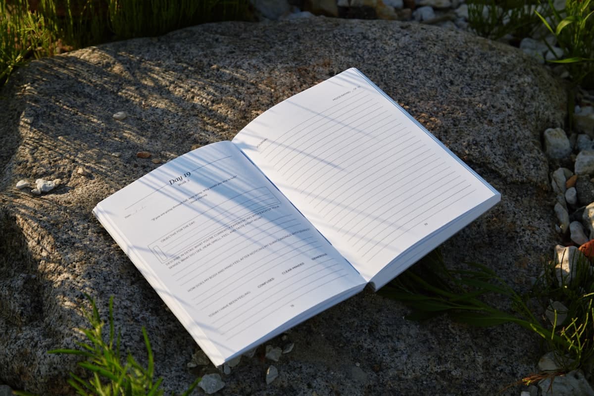 Open ForgeLogbook showing handwritten volume and intensity tracking columns with a weekly summary row highlighted at the bottom of the page