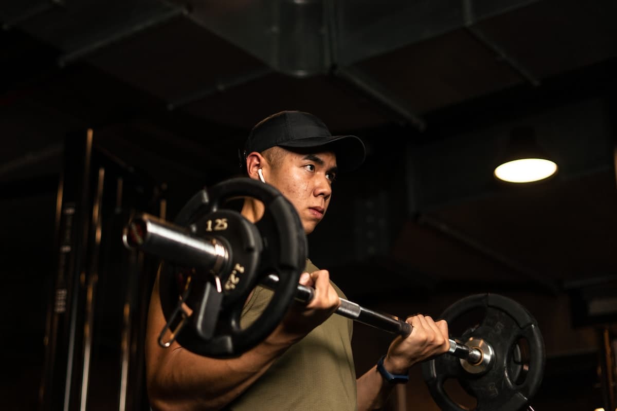 Focused lifter preparing mentally before a barbell lift in the gym