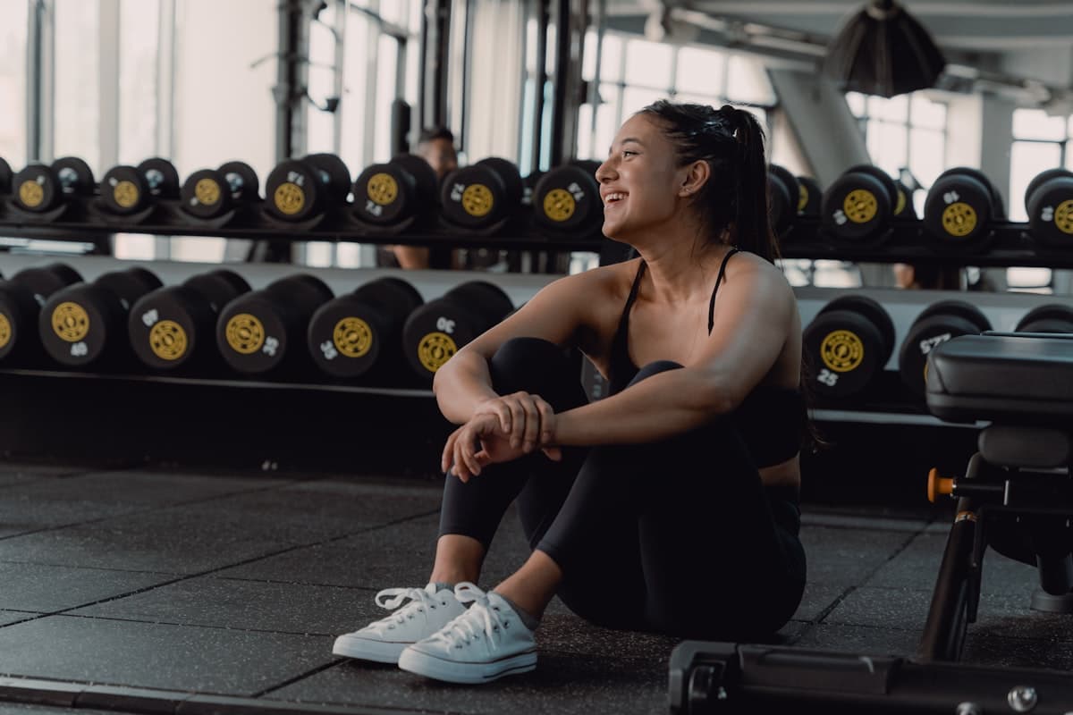 Beginner lifter in a gym looking at equipment and getting started
