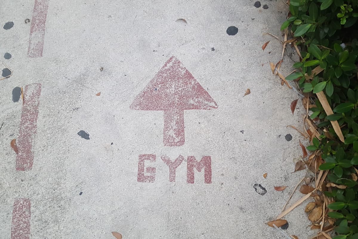Frustrated lifter looking at a messy, inconsistent workout logbook